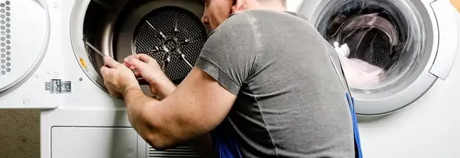 Dryer repair technician fixing a clothes dryer drum in Savannah, GA