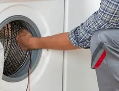 Dryer repair technician diagnosing and servicing a clothes dryer in Savannah, GA