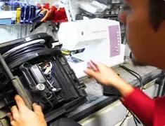 Vacuum repair technician servicing internal components on a workbench in Savannah, GA