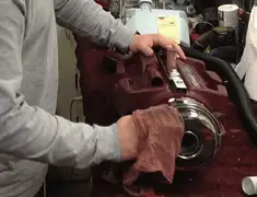 Vacuum repair technician cleaning and servicing a vacuum motor in Savannah, GA