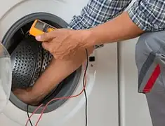 Washing machine repair technician testing a front-load washer with diagnostic tools in Savannah, GA